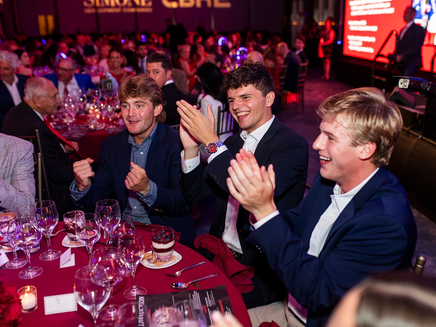 Table of men clapping.
